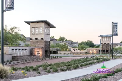 Custom community entrance with organized planting, roundabout and cantilevered planting.