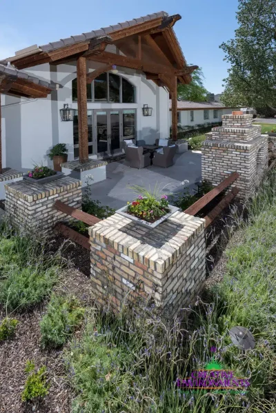 Custom backyard design with brick columns, wok planters and brick fireplace.