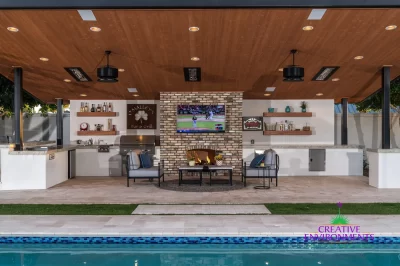 Custom backyard design with deco-tile pool, recessed lighting and outdoor BBQ.