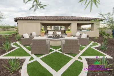 Custom backyard design with artificial turf pattern, fire pit and outdoor shade structure.