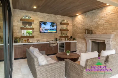 Custom backyard design with natural wood accents, fireplace and outdoor bar.