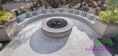 Custom backyard design with half-moon fire pit seating, large planters and desert contemporary vibes.