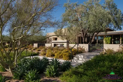 Custom backyard design with metal fencing, metal hand rail and organized planting.