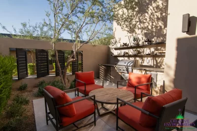 Custom backyard design with metal shutters, outdoor shelving and outdoor seating area.