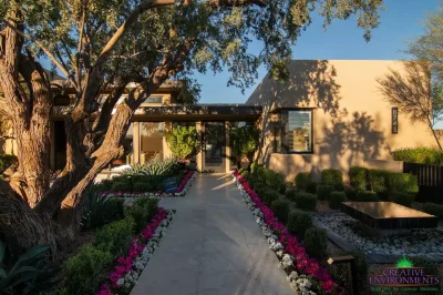 Custom entryway design with annuals, black water feature and natural stone paver walkway.